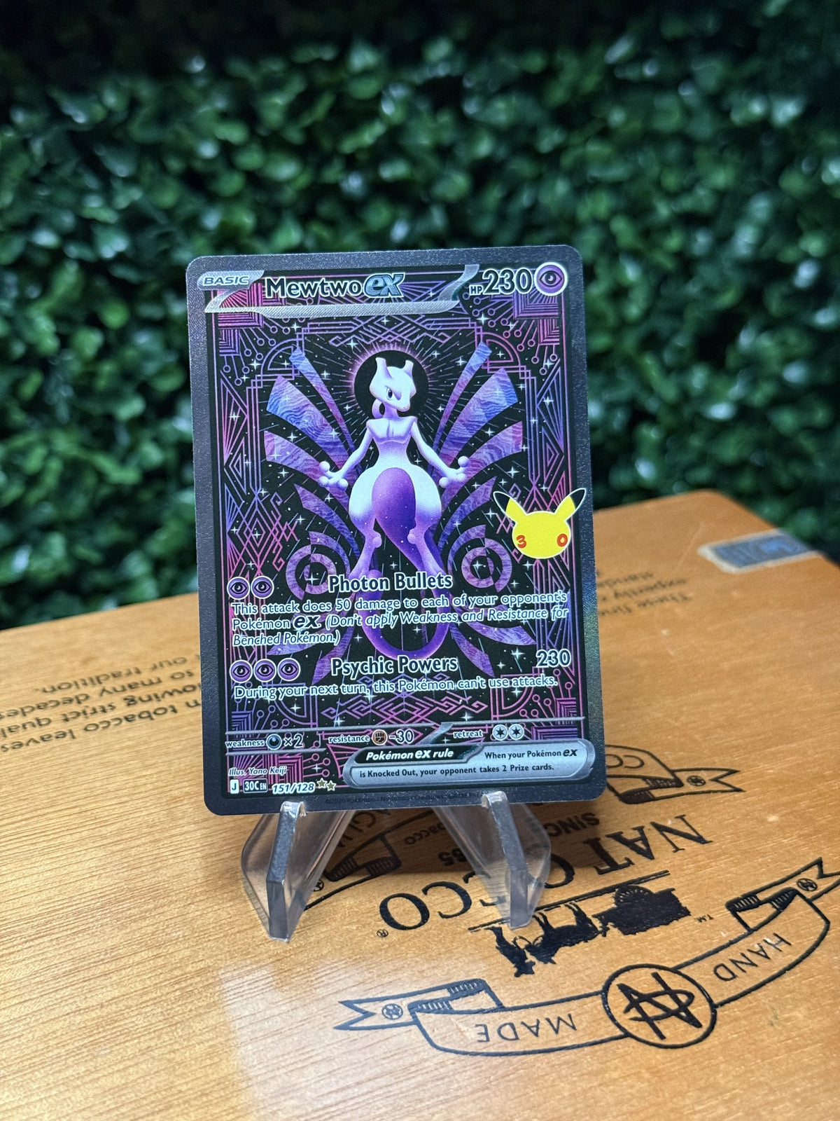 Mewtwo ex collector card with purple artwork and anniversary-style mark